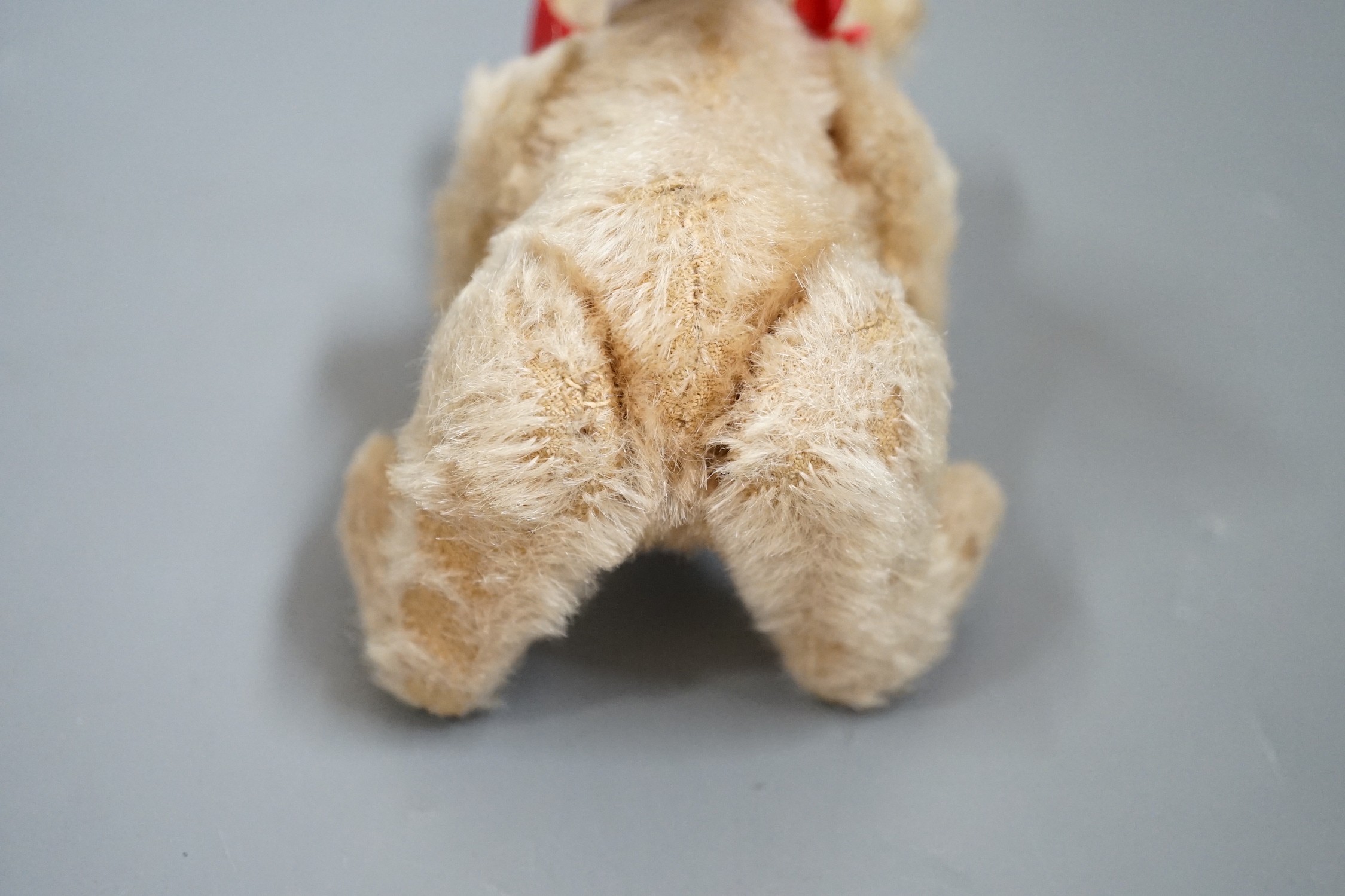 A small Steiff bear, with button in ear, c.1920, 14cm high